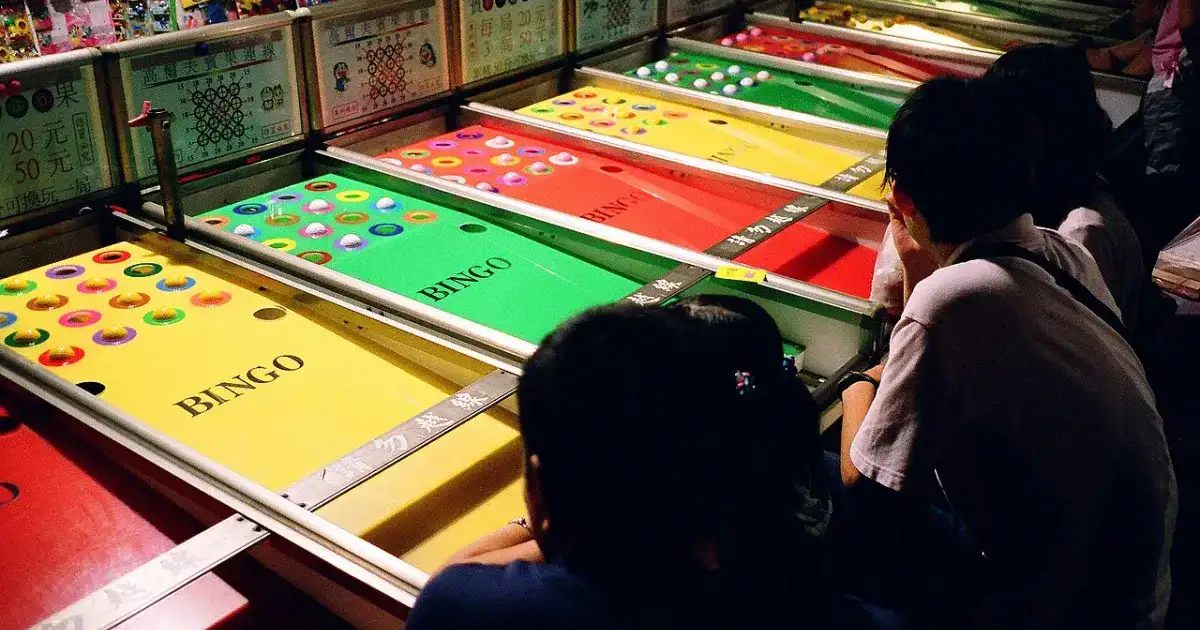 Bingo arcade game with colorful lights at a night market