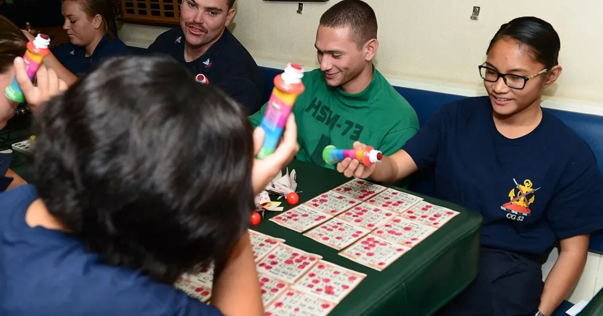 Group of friends playing bingo together with colorful daubers
