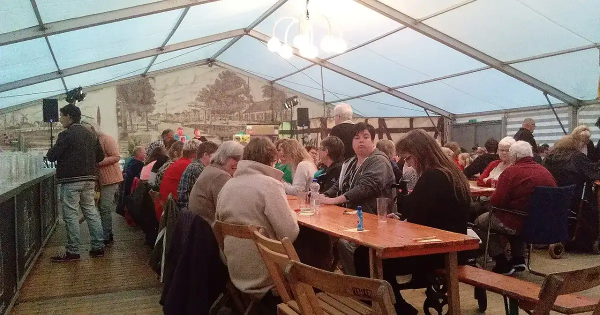 People playing bingo together at community event tables