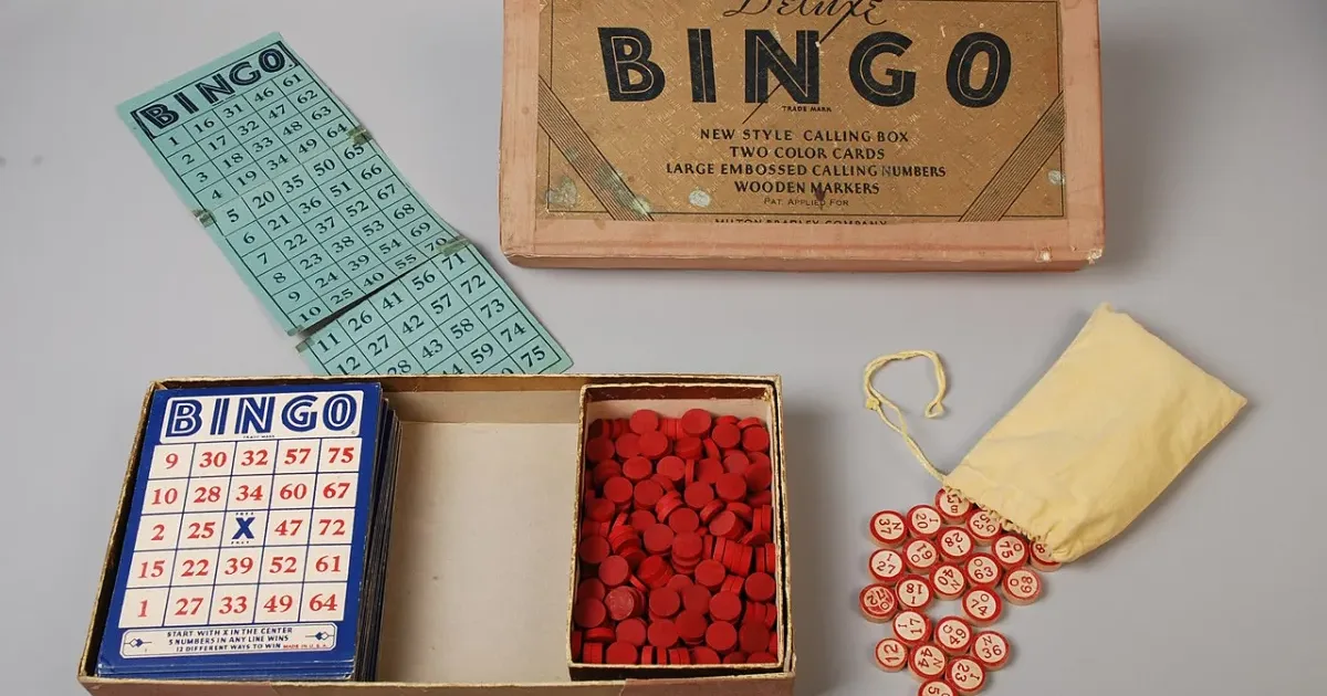Vintage bingo kit with cards, red chips, numbered tokens and box